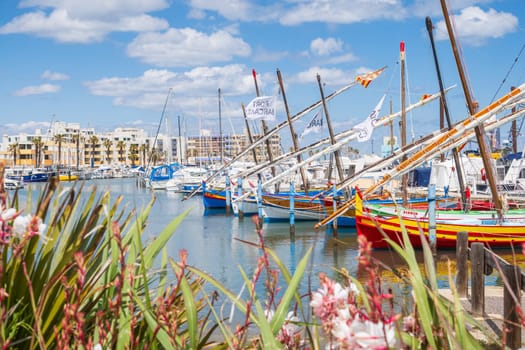 Le Barcarès, France - May 22, 2024: The fishing and marina port photographed in bright light and vivid colors. Fishing boats displayed in foreground