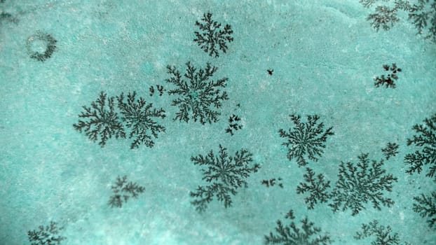 A pattern of natural snowflakes on a stone .Macrophotography.Texture or background