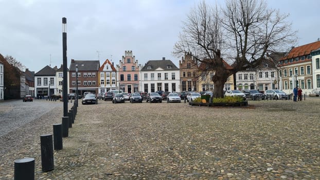 KALKAR NRW, GERMANY - NOVEMBER 14, 2021: Kalkar, Nrw, Germany - November 14, 2021:  Trees and houses in the city against the sky in autumn