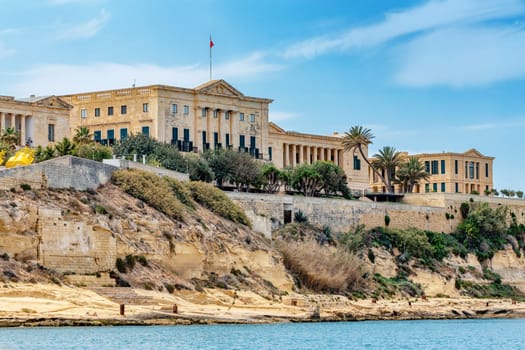 The historic Bighi Complex in Kalkara, Malta, featuring imposing architecture and coastal views along Triq Marina. Cultural heritage of Malta