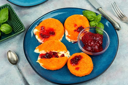 Baked and melted camembert cheese with berry sauce