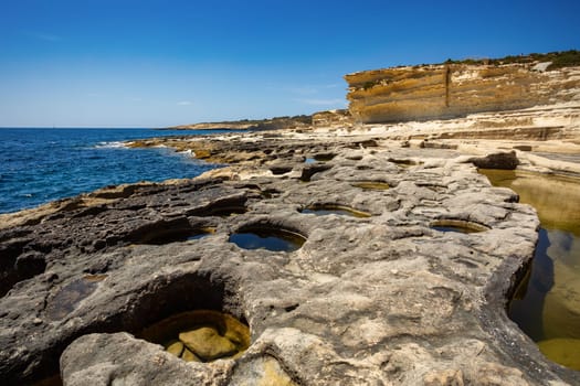 Beautiful coastal view of Delimara peninsula, with rocks and turquoise sea, near Saint Peter's Pool, Island Malta natural landscape.