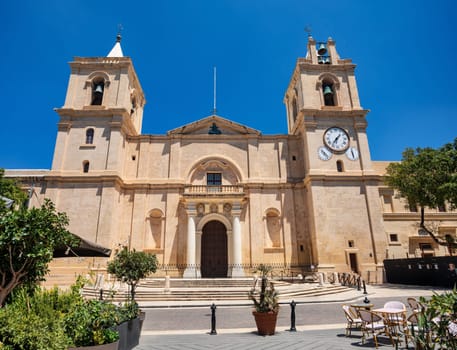 Exterior view of St. John's Co-Cathedral showcasing Baroque architectural style with carved stone details in Valletta. Cultural heritage of Malta