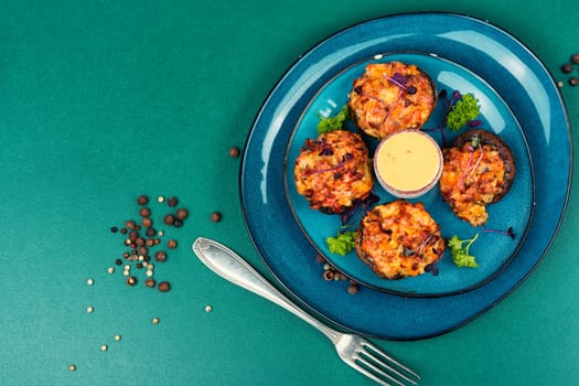 Stuffed mushrooms, champignon mushroom caps filled with vegetables on rustic wooden table. Healthy food