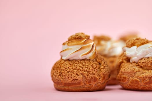 Tasty sweet cupcakes on the pink background