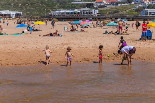 Sintra, Portugal: April 13, 2024: People at the beach of Foz do Lizandro, Ericeira, Portugal