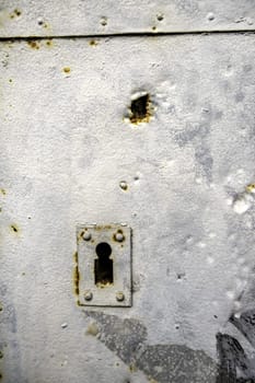 Detail of old damaged and abandoned wooden door, rust