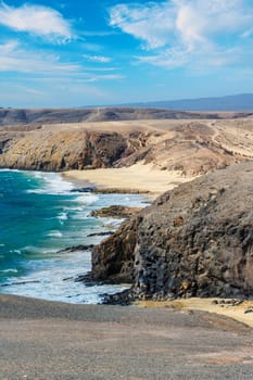 View of the Atlantic Ocean with its rocky cliffs and the beautiful Papagayo beaches on the Canary Island of Lanzarote in the Atlantic Ocean