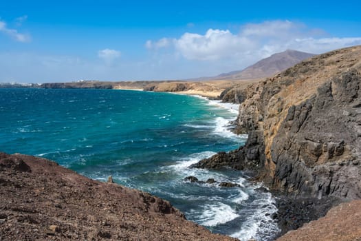 View of the Atlantic Ocean with its rocky cliffs and the beautiful Papagayo beaches on the Canary Island of Lanzarote in the Atlantic Ocean