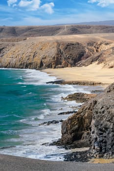 View of the Atlantic Ocean with its rocky cliffs and the beautiful Papagayo beaches on the Canary Island of Lanzarote in the Atlantic Ocean