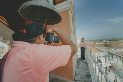Tourists taking photographs at the viewpoint of the La Merced church, Granada. Tourist couple taking pictures at the viewpoint of the La Merced church