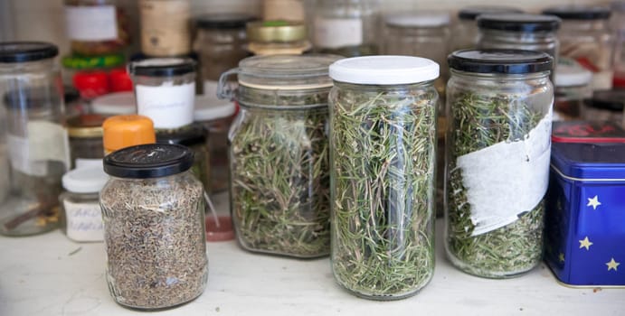 Cupboard full of glass jars with natural home remedies. Closseup