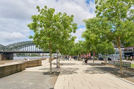 Kennedy bank, Kennedy-Ufer in Cologne on the Rhine with walkers on a beautiful day in May