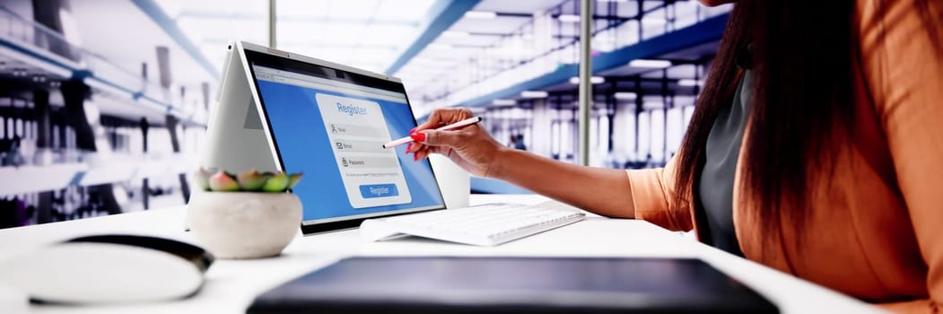 Businesswoman's Hand Filing Online Registration Form On Laptop