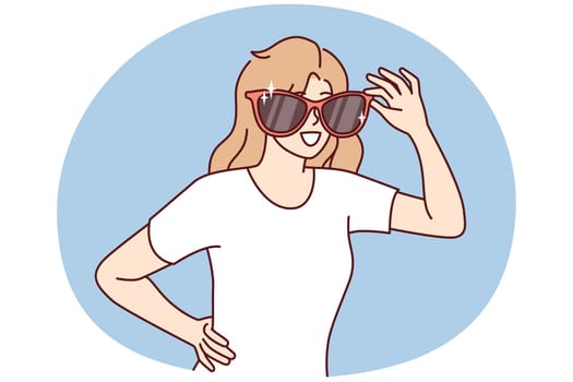 Happy woman with giant sunglasses on face smiles and looks around looking for acquaintances. Positive girl in casual t-shirt of department sunglasses for going to beach or walking in summer park