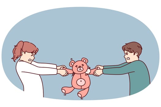 Preteen boy and girl argue over right to play with teddy bear in attempt to take toy away from rival. Kindergarten children are unwilling to share toys after disagreement or conflict
