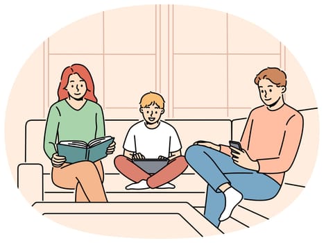 Family is sitting on couch ignoring each other for concept of communication problems. Mom and dad with their son are passionate about different things and need communication for family happiness