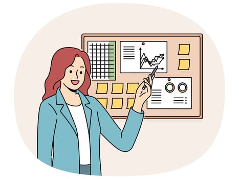 Businesswoman demonstrates financial graphs and charts pinned on cork board in office. Businesswoman boasts about growth of company income and number of clients that bring income to business.