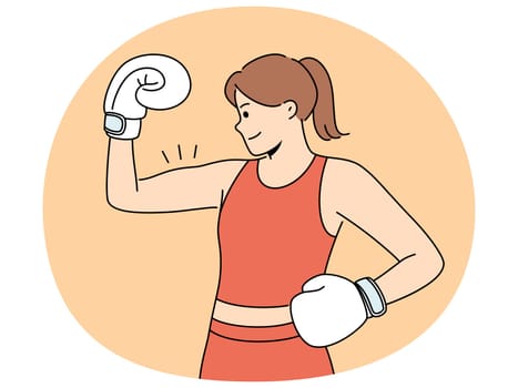 Woman boxer shows biceps and smiles demonstrating strength and determination to defeat opponent. Girl boxer in boxing gloves and sportswear poses at weigh-in ceremony before important tournament