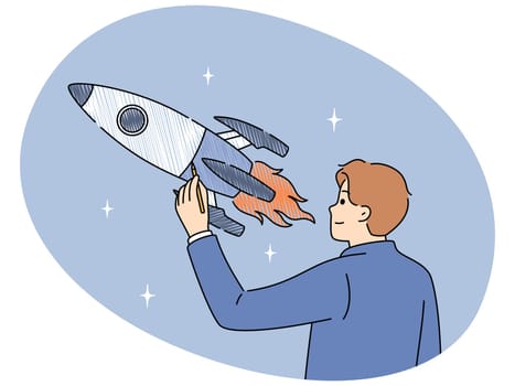 Businessman draws space rocket symbolizing successful launches and business ambitions or striving to achieve goals. Concept of starting and developing your own business or looking for investments