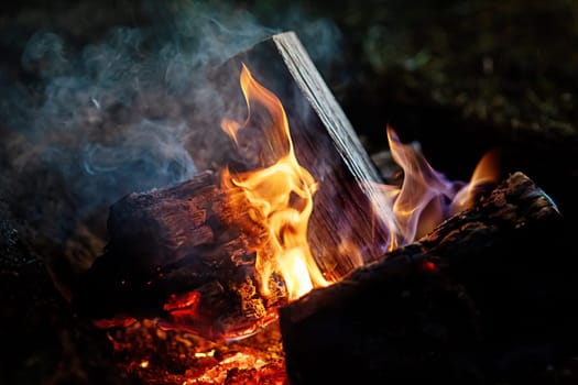 Bright burning fire with embers in front of black background