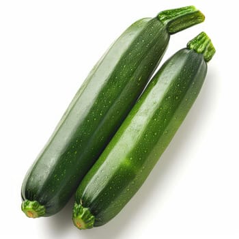 Two fresh zucchini on a white background, showing off their vibrant green color and natural texture