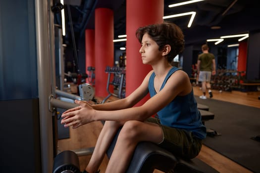 Boy athlete smiling happy with his gym workout. Happy sportive childhood, healthy lifestyle and body training