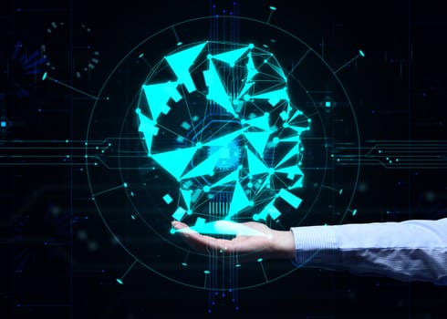 The concept of teaching artificial intelligence to various tasks, replacing human mental labor. Above the female hand is a luminous hologram of the head with connections