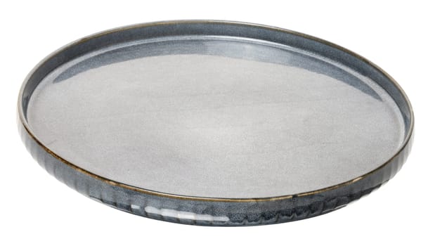 Empty blue round ceramic plate at an angle on isolated background