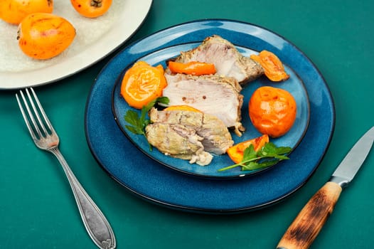 Homemade meat baked with succulent loquat fruits. Delicious piece of meat roasted with medlar fruit