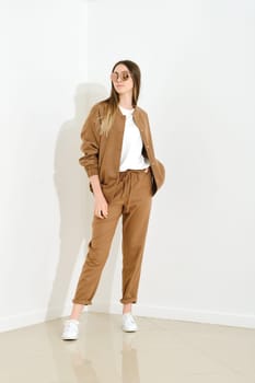 Young woman in brown jersey sports suit and sunglasses