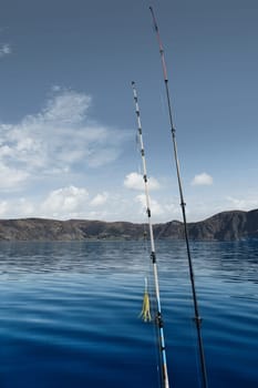Fishing boat with fishing rod off Bergen in the Norwegian fjord landscape. Crystal clear water in Scandinavia