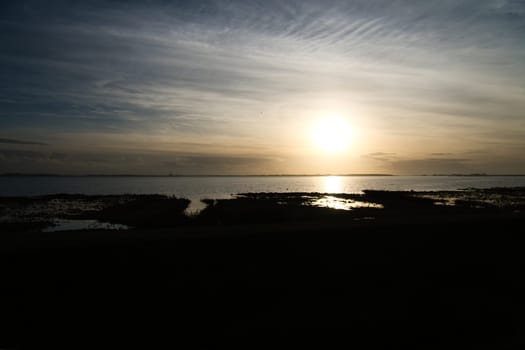 Sunset on the Bodden in Zingst on the Baltic Sea peninsula. Bodden landscape with meadows. Nature reserve on the coast. Landscape photograph