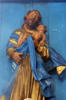 Saint Joseph holding the baby Jesus, statue on the Altar of Saint Joseph in the Parish Church of the Assumption of the Virgin Mary in Gornja Rijeka, Croatia