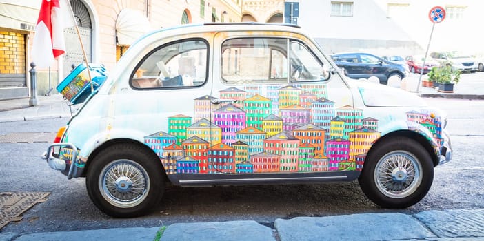 Genova, Italy - 6 August 2023: vintage Fiat 500 car painted with traditional cityscape of Liguria Region - Italy travel destination