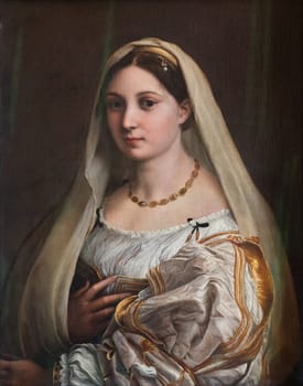 Florence, Italy - 23 September 2023: Pitti Palace antique painting museum. The vailed woman - La velata - by Raphael - Raffaello Sanzio, 1514.