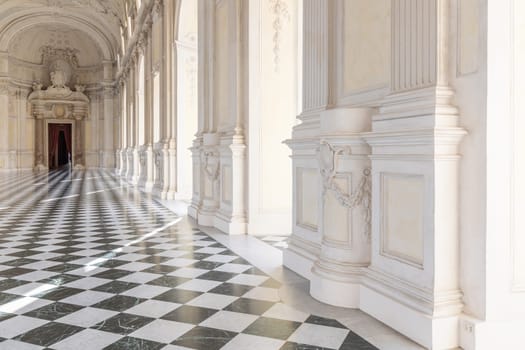 Reggia di Venaria Reale, Italy - October 2022: corridor perspective, luxury marble, gallery and windows - Royal palace