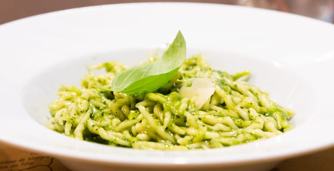 Traditional Italian food - trofie al pesto, typical regional pasta from Liguria region, with basil sauce