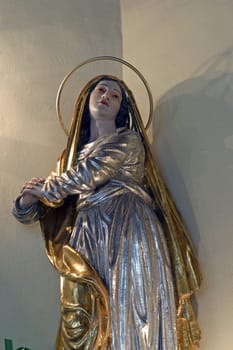 Virgin Mary under the cross, statue on the main altar in the parish church Exaltation of the Holy Cross in Kravarsko, Croatia