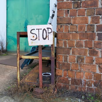 Sign with the inscription Stop on an abandoned company site on the outskirts of Magdeburg in Germany