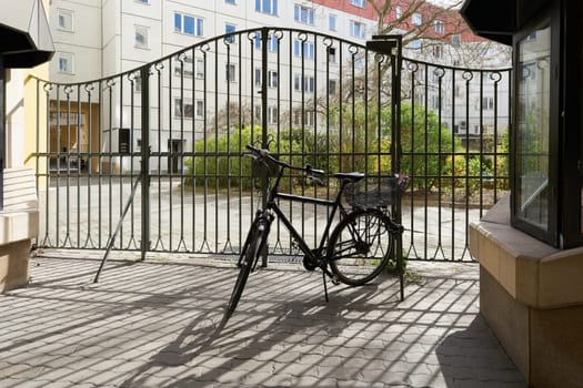 Bicycle parked at a gate to a backyard in the Nikolaiviertel, Nikolai Quarter in Berlin-Mitte