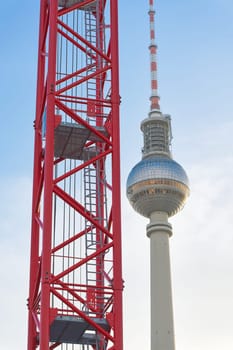 Construction crane at a building site in Berlin with the television tower in the background
