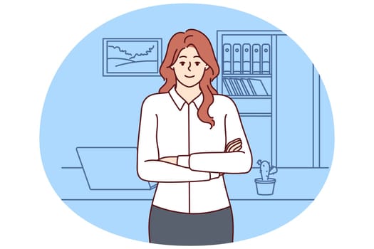 Successful woman office worker stands with arms crossed near desktop and looks at screen. Businesswoman works as accountant or provides auditing services for entrepreneurs and successful business