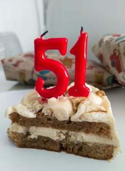 Cake with numeral birthday unlit candles. 51 years
