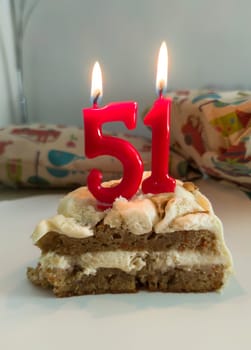 Cake with numeral birthday lit candles. 51 years