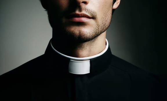 Close-up of a young male priest wearing a traditional clerical collar, emphasizing the religious attire.