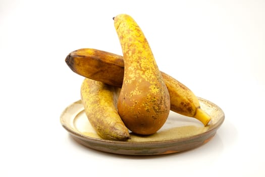 Pears and banana on a ceramic plate