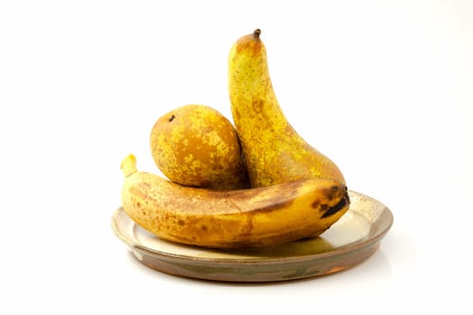 Pears and banana on a ceramic plate