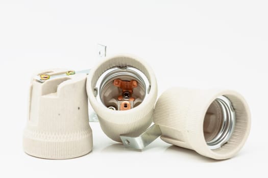 Electric ceramic socket model E27, for lighting. Selective focus with shallow depth of field.