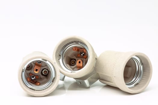 Electric ceramic socket model E27, for lighting. Selective focus with shallow depth of field.